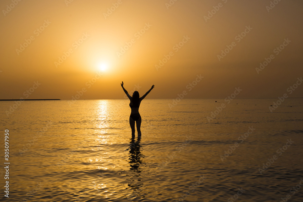 UAE. Woman sea, sunset