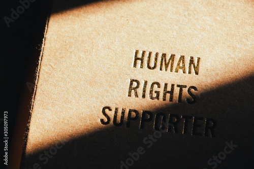 human rights concept. human rights text on cover note book with light of sun feel hopeful. 
