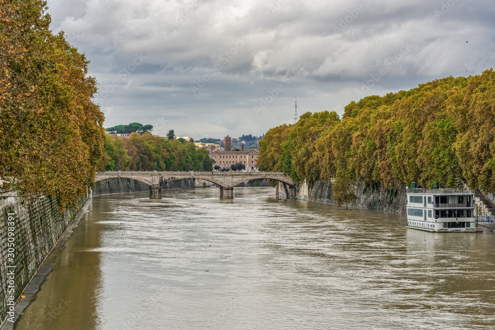 Rome, Italy Tiber river high tide water rise. Day view of high water level flooding the banks of the river crossing the Italian capital, after heavy rain.