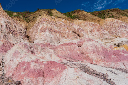 Landscape of pink, white and yellow rock formations at Interpretive Paint Mines in Colorado