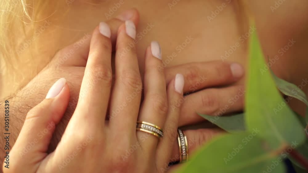 Crossed hands of the bride and groom with gold rings. Crossed hands of the bride and groom with gold rings.