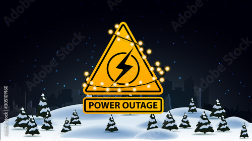 Power outage, yellow warning logo wrapped with a garland on the background of the city without electricity and winter landscape