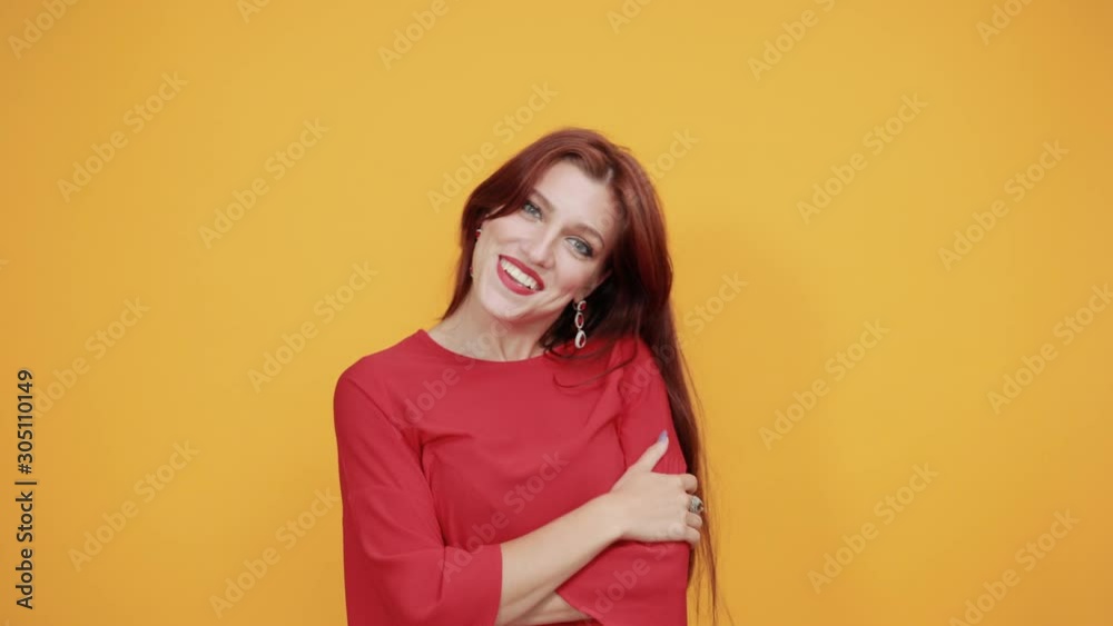 Lady in red dress meeting with new people and getting to mingle, and she is kind of impressed by the person she met. She is saying 'hi' and smiling is well as she is happy. Lady in red dress meeting with new people and getting to mingle, and she is kind of impressed by the person she met. She is saying 'hi' and smiling is well as she is happy.