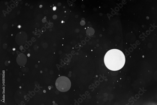 Snow or rain bokeh texture on black background