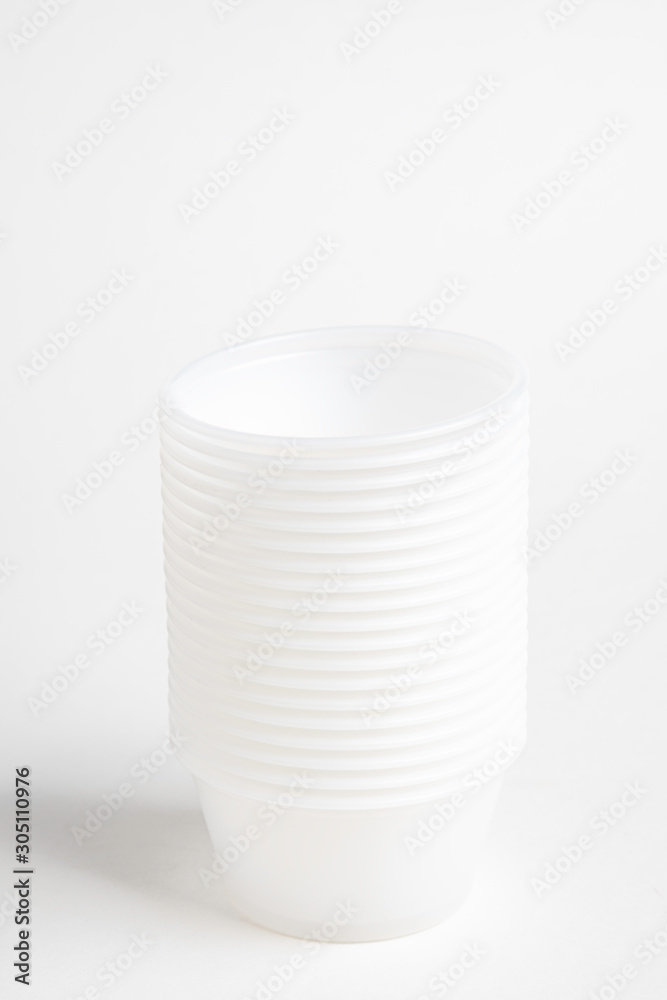 Obraz premium A stack of small plastic container for specimen medical laboratory testing set on a white background.