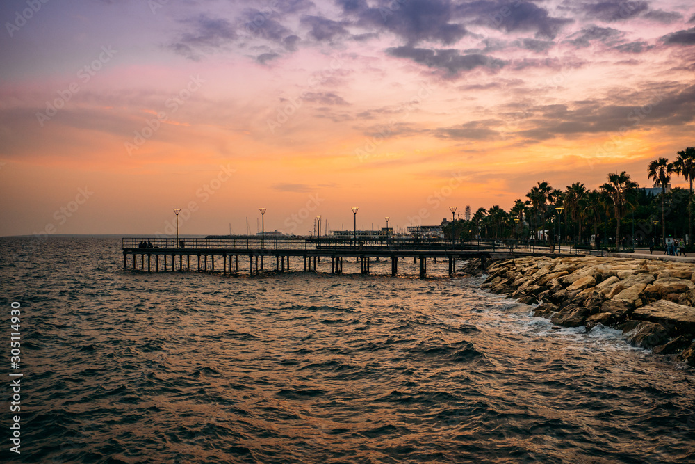 Pier at Molos Promenade park at sunset in Limassol city ,Cyprus. Beautiful evening mediterranean sea resort.