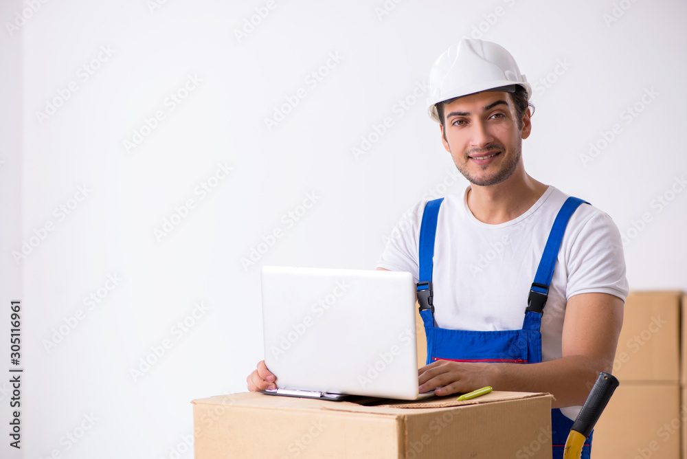 Young male professional mover doing home relocation Young male professional mover doing home relocation