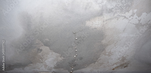 dampness moisture on ceiling with drops of water infiltration