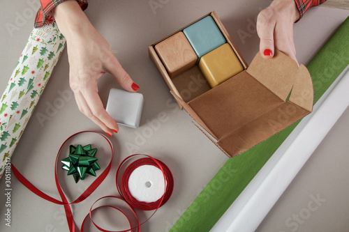 Woman wrapping Christmas presents, winter hoildays, gifting season concept	 photo