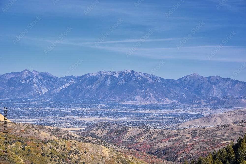 Panoramic view of Wasatch Front Rocky Mountains from the Oquirrh Mountains with fall leaves, by Kennecott Rio Tinto Copper mine, Utah Lake and Great Salt Lake Valley. Utah, America.