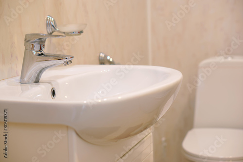 An example of installing a washbasin and toilet in one room. House, quarter, apartment or hotel
