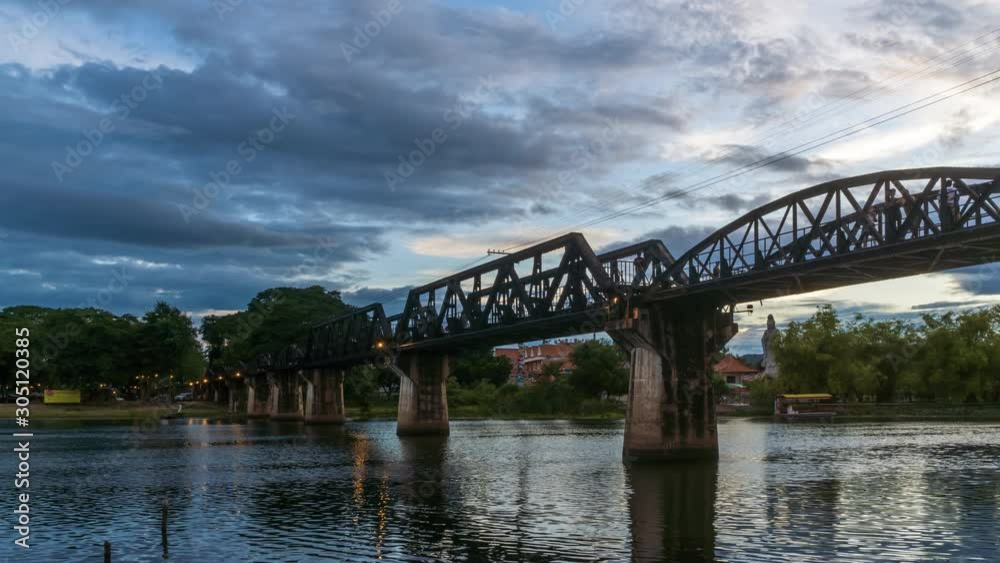 Historical bridge over River Kwai, and Death Railway, built by Japanese and prisoner during World War II, Kanchanaburi, Thailand; day to night, zoom out - Time Lapse Historical bridge over River Kwai, and Death Railway, built by Japanese and prisoner during World War II, Kanchanaburi, Thailand; day to night, zoom out - Time Lapse