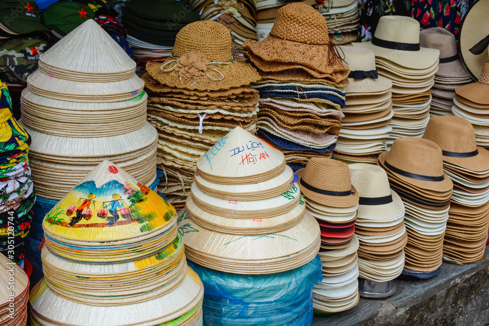 Panama and conical Asian hats for sale in a street market in Hoi An, Vietnam