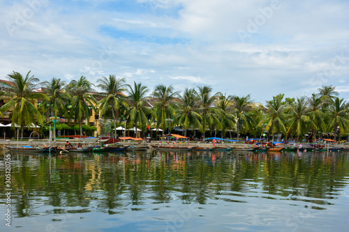 Beautiful view of boats and palm trees along Thu Bon River in Hoi An, Vietnam © lrpizarro