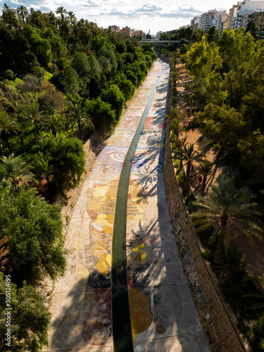 cement irrigation canal with vinalopo river colors as it passes through elche photo