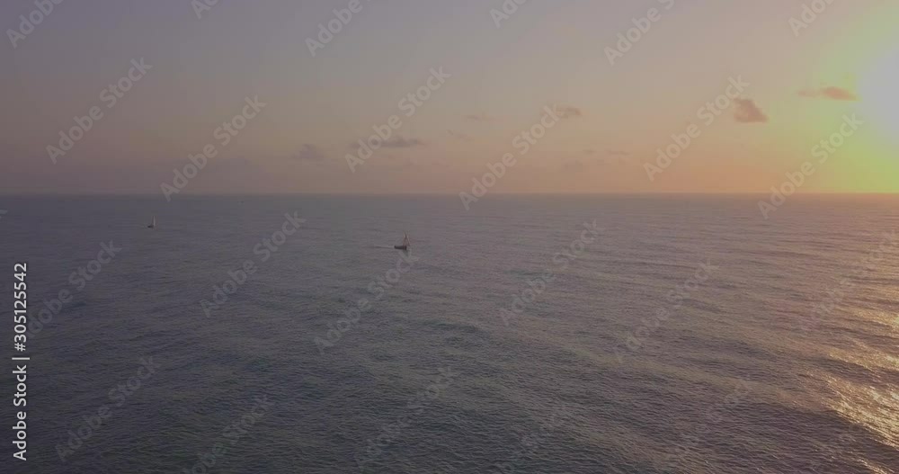 Traditional dhow sailboat sailing on the Indian ocean on the Swahili coast filmed with a drone, Tanzania. Traditional dhow sailboat sailing on the Indian ocean on the Swahili coast filmed with a drone, Tanzania.