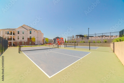 Wallpaper Mural Tennis court at a neighborhood with townhouses and playground in the background Torontodigital.ca
