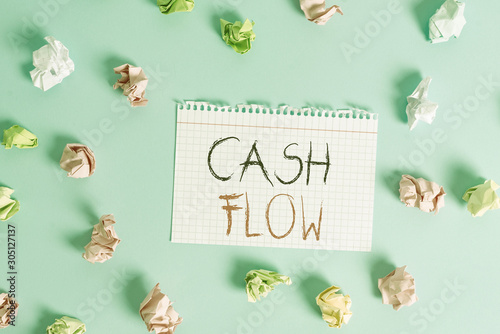 Word writing text Cash Flow. Business photo showcasing Movement of the money in and out affecting the liquidity Colored crumpled rectangle shaped reminder paper light blue background photo