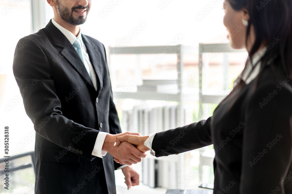 Business men Shaking Hands and Smiling with business women women after agreeing to work together in office.