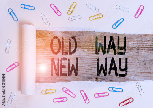 Conceptual hand writing showing Old Way New Way. Concept meaning The different way to fulfill the desired purposes Paper clip and torn cardboard on wood classic table backdrop