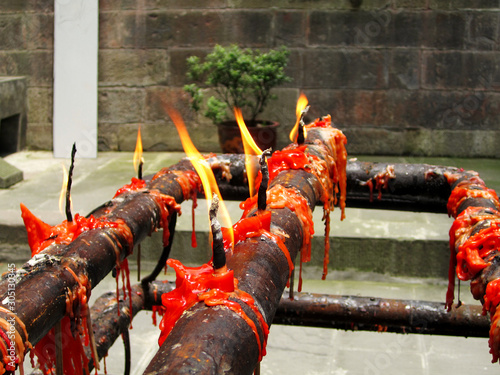 Melted red candles (lit on fire) at a Buddist temple, Beijing, China photo