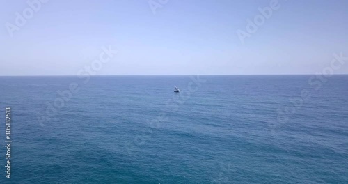 Traditional dhow sailboat sailing on the Indian ocean on the Swahili coast filmed with a drone, Tanzania.