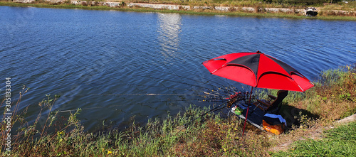 Fototapeta Naklejka Na Ścianę i Meble -  fishing in a reservoir. Multiple fishing rods are unfolded