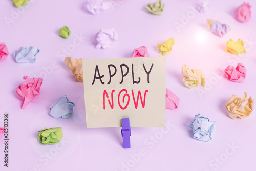Word writing text Apply Now. Business photo showcasing An act of a demonstrating to acquire the job related to the profession Colored crumpled papers empty reminder white floor background clothespin © Artur