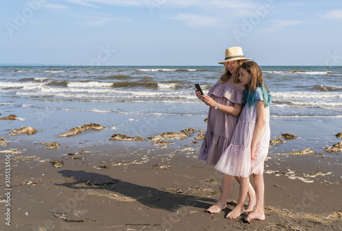 Happy mom and daughter spend time together at the seaside, Make Selfie, Family Concept.