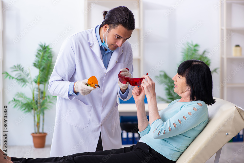 Fototapeta premium Old woman visiting young doctor dentist