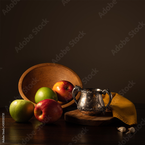 Apples in Wooden Bowl with Antique Silver Cup and Garlic