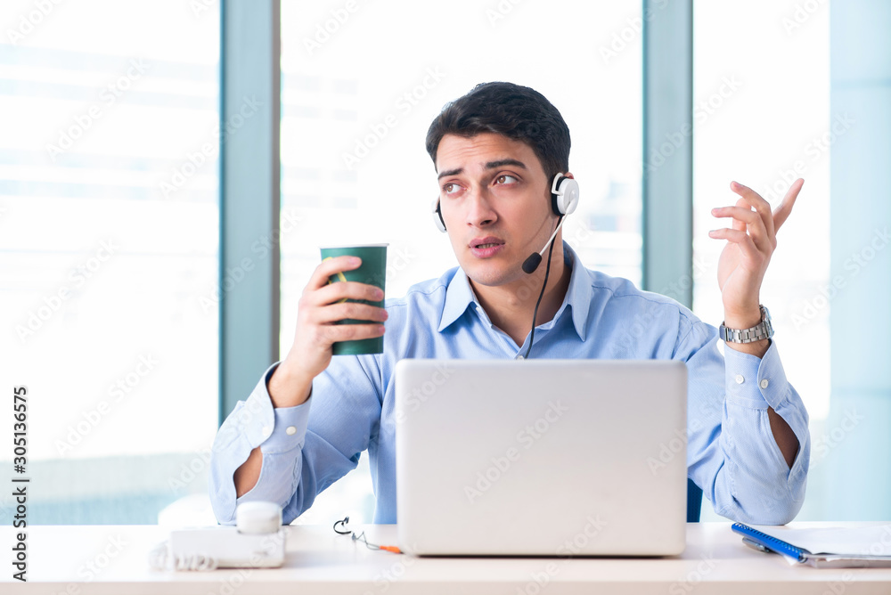 Male call-center operator in business concept Male call-center operator in business concept