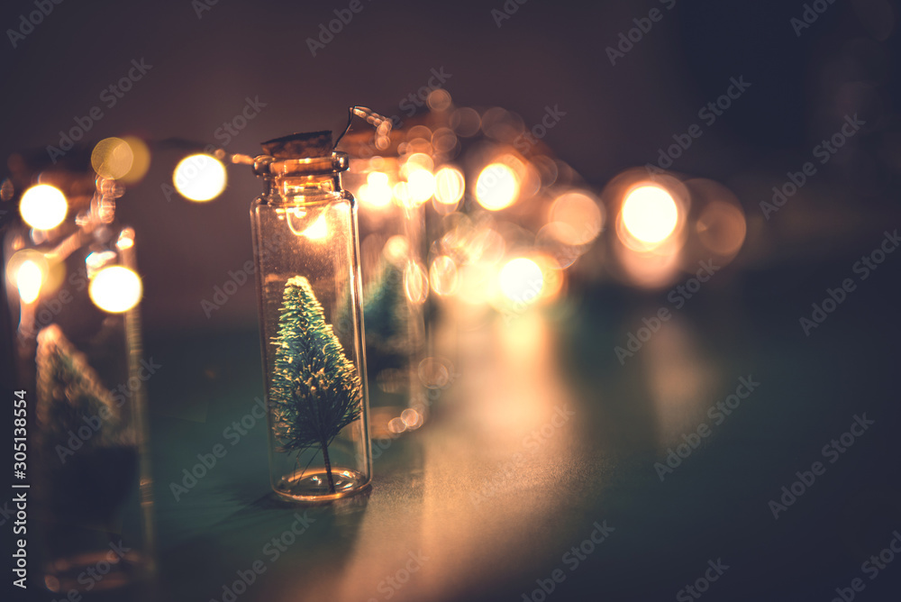 Close-up, Elegant Christmas tree in glass jar on green color background. copy space - obrazy, fototapety, plakaty 