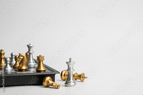 Tableau sur Toile Chess leadership concept with gold and silver chess isolated in white background