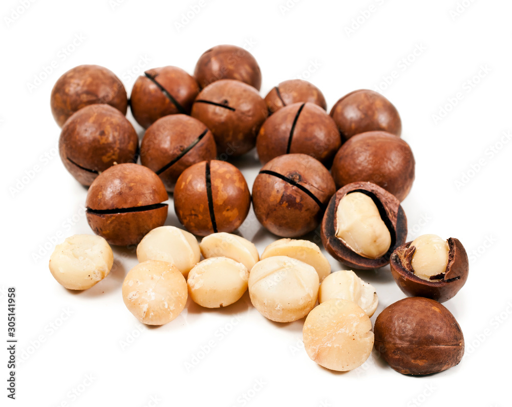 Macadamia nuts heap isolated on a white background. Macadamia nuts heap isolated on a white background.