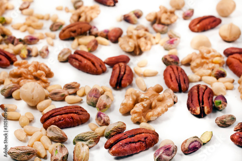 Background of different nuts. Pecan, macadamia, pistachio, pine nuts, walnuts.
