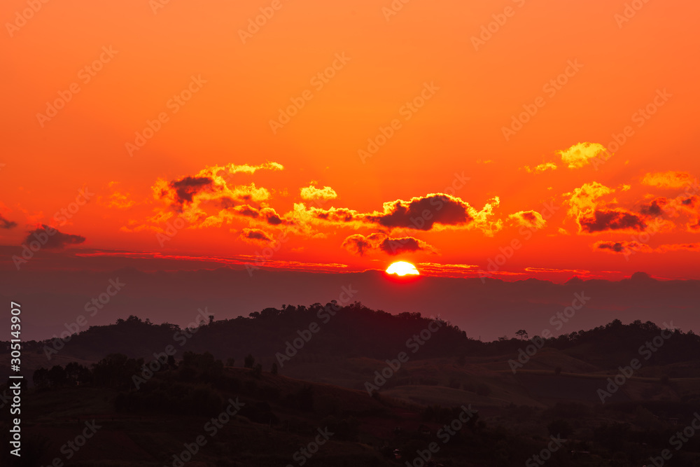 The sunset at the mountain peak in the evening has clouds with beautiful rays. The sunset at the mountain peak in the evening has clouds with beautiful rays.