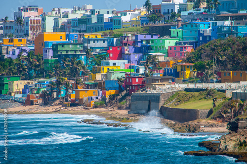 Colorful houses line the hill side overlooking the beach in San Juan, Puerto Rico.