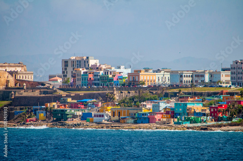 Colorful houses line the hill side overlooking the beach in San Juan, Puerto Rico.