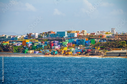 Colorful houses line the hill side overlooking the beach in San Juan, Puerto Rico. photo
