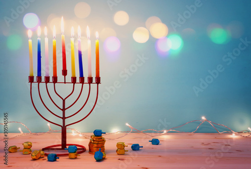 religion image of jewish holiday Hanukkah background with menorah (traditional candelabra) and spinning top
