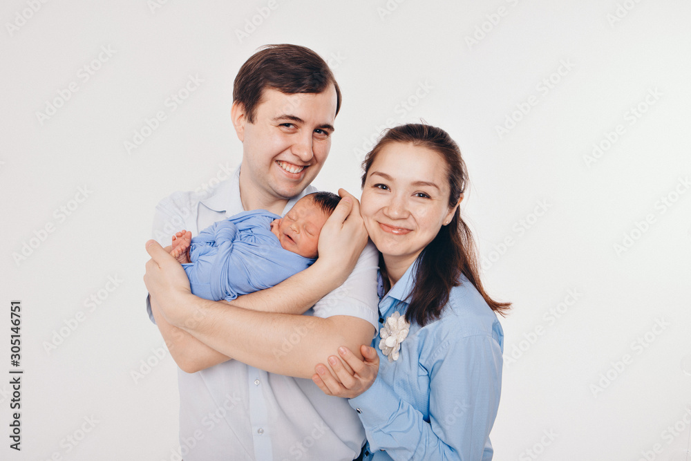 the concept of a healthy lifestyle, the protection of children, shopping - baby in the arms of the mother and wather. Woman and man holding a child the concept of a healthy lifestyle, the protection of children, shopping - baby in the arms of the mother and wather. Woman and man holding a child