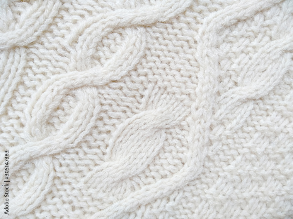 Background of wool yarn for yarn frame. White knitting yarn for handicrafts background. Knitted clothes from wool yarn. Background of wool yarn for yarn frame. White knitting yarn for handicrafts background. Knitted clothes from wool yarn.