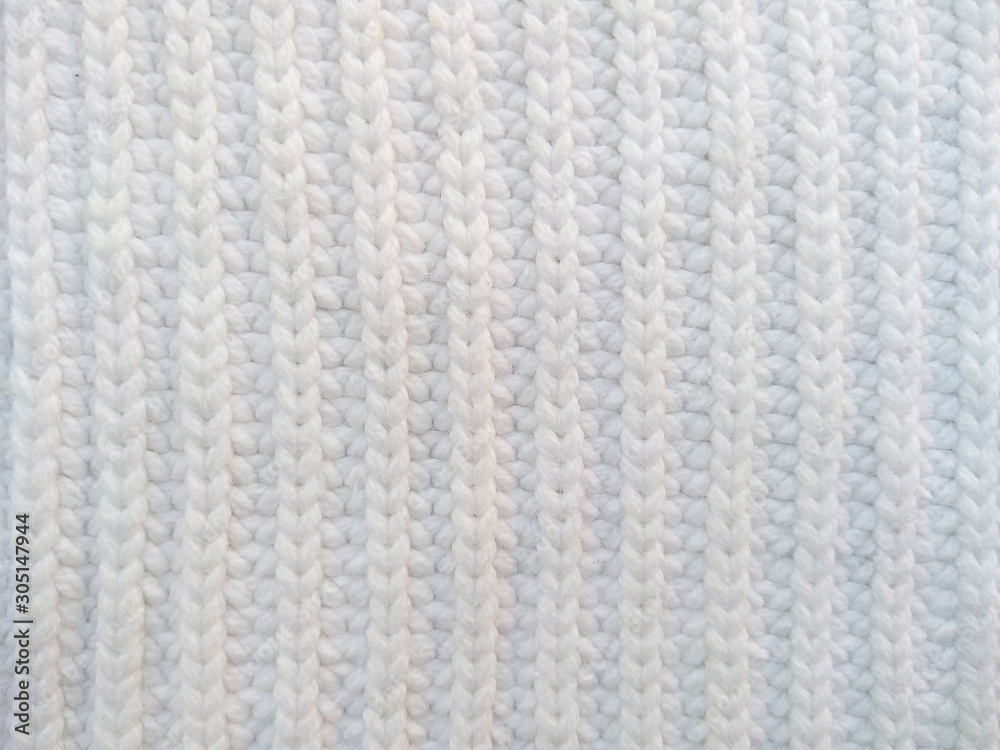 Background of wool yarn for yarn frame. White knitting yarn for handicrafts background. Knitted clothes from wool yarn. Background of wool yarn for yarn frame. White knitting yarn for handicrafts background. Knitted clothes from wool yarn.