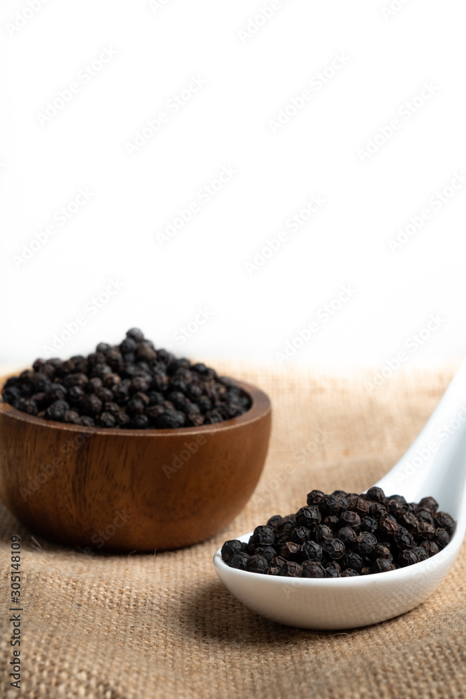 Fresh black cambodian pepper corn in bowl, cooking preparation Fresh black cambodian pepper corn in bowl, cooking preparation