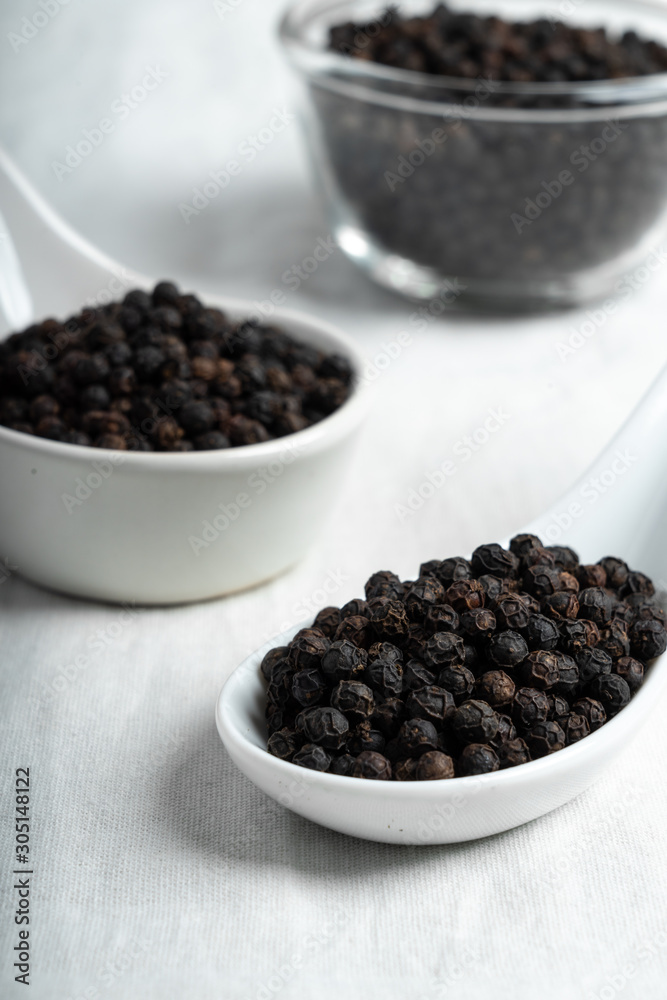 Fresh black cambodian pepper corn in bowl, cooking preparation Fresh black cambodian pepper corn in bowl, cooking preparation