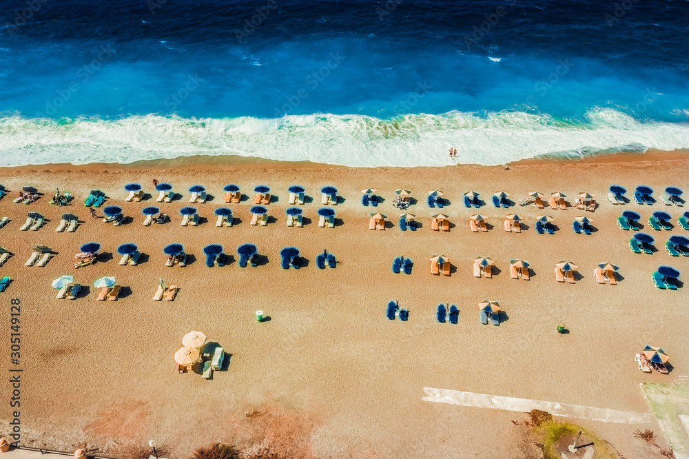 Aerial view of sandy beach with tourists swimming in beautiful clear sea water. Greece Europe Aerial view of sandy beach with tourists swimming in beautiful clear sea water. Greece Europe