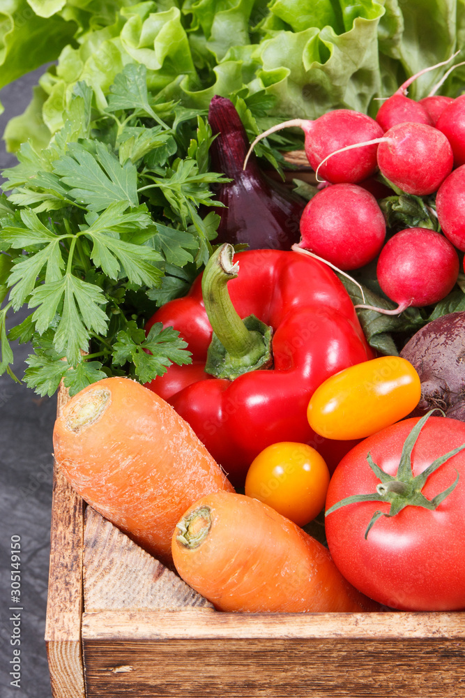 Fresh ripe vegetables in wooden box as healthy snack containing vitamins Fresh ripe vegetables in wooden box as healthy snack containing vitamins