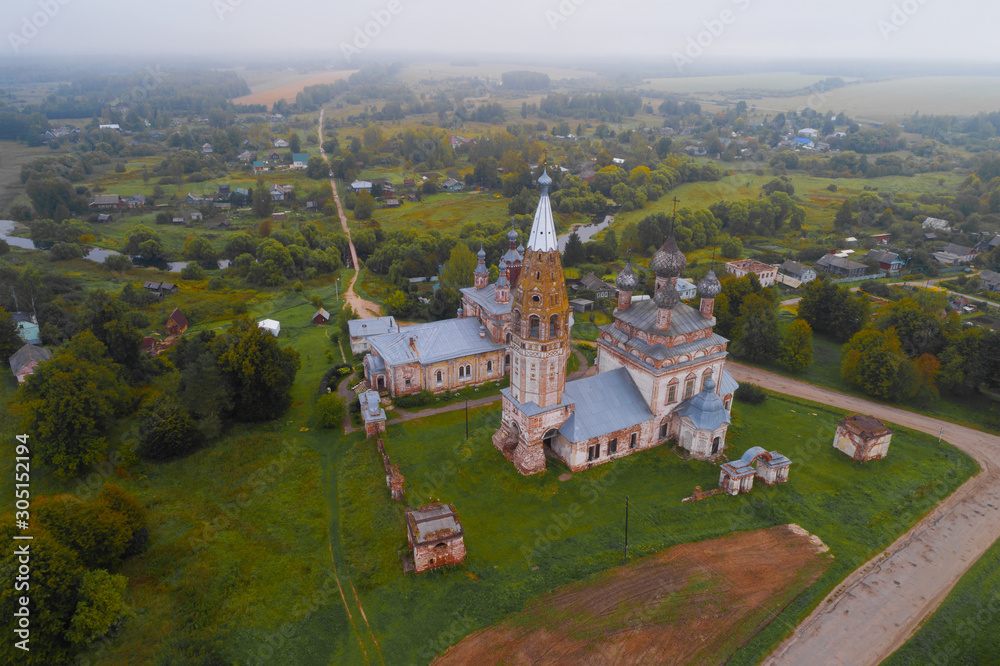 View of the old temple complex in the Parskoe village on a foggy September morning (aerial photography). Ivanovo region, Russia