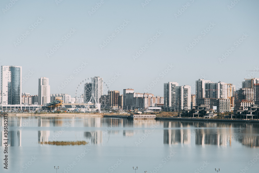  Silhouette of a modern city. Day panorama of Kazan and the river.